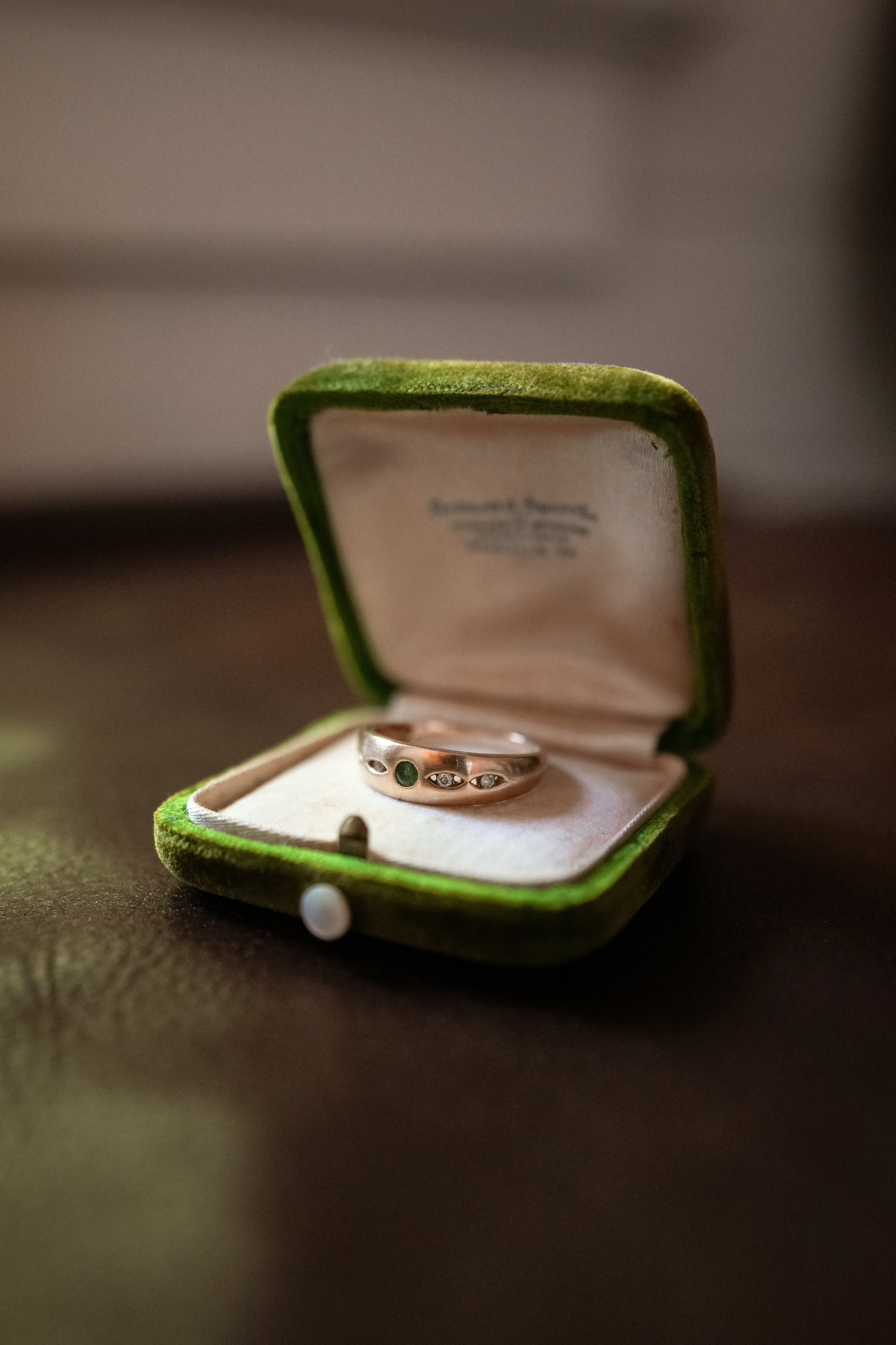 Vintage 14K gold ring with emerald center stone and diamond starburst accents