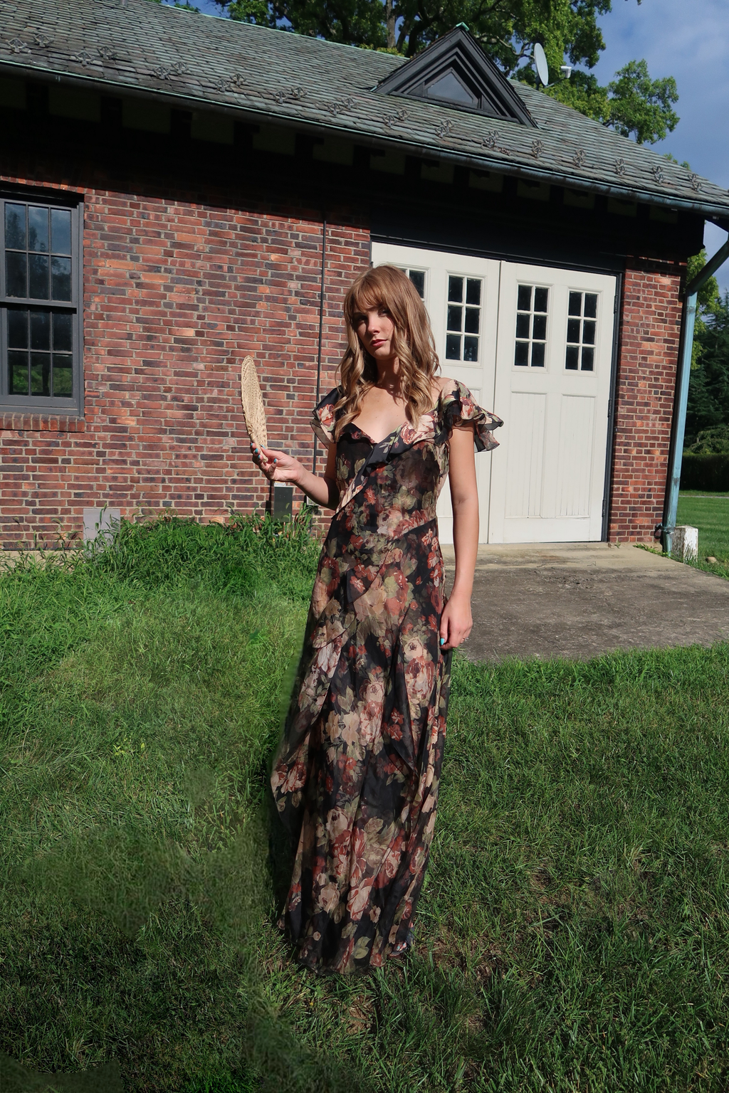 Ralph Lauren Collection Brienne crinkle chiffon gown in a dark romantic floral print, featuring cascading ruffles, a V-neckline, and a floor-length silhouette.