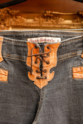 Front view of Electric Barbarella vintage low rise jeans with tan leather lace up fly closure
