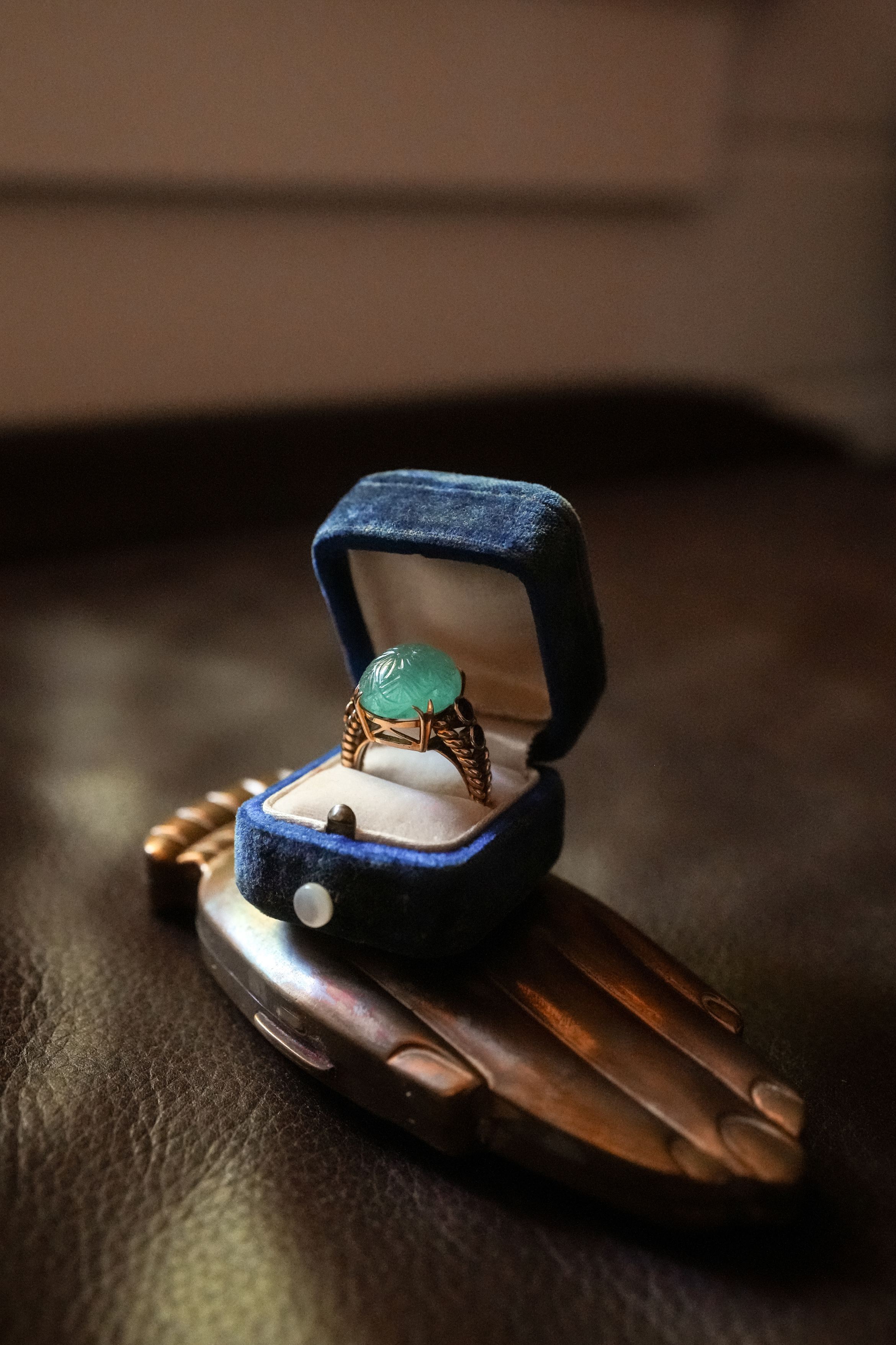 hand-carved seafoam-green jade floral cabochon and sapphire accent ring